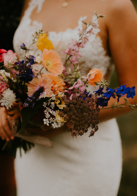 Detail shot of the bridal bouquet featuring bright, seasonal blooms